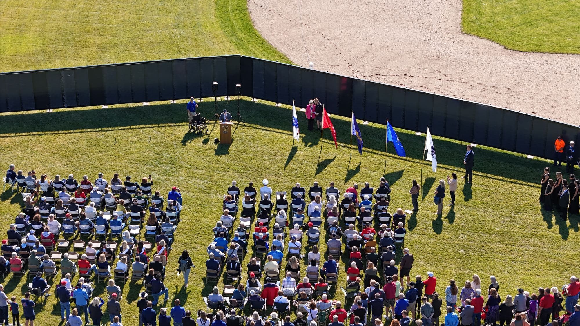 An aerial view of a Welcome Home ceremony held within the chevron of The Wall That Heals