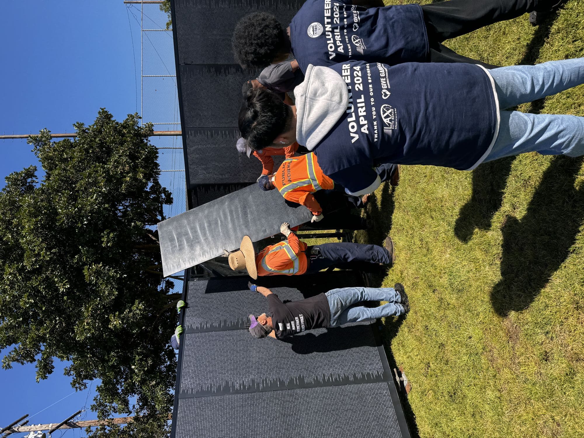 Volunteers carefully set the final panel of The Wall That Heals into place